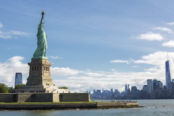 statue of liberty and the new york city skyline